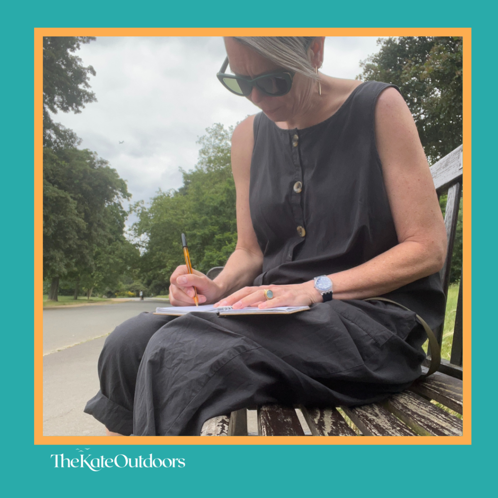 Kate writing notes after a coaching session - in Dulwich Park SE22