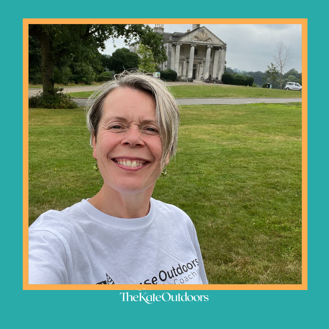 A smiling Kate wearing her Pause Outdoors t-shirt in Beckenham Place Park